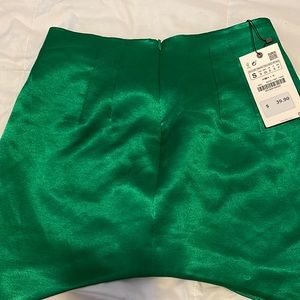 Silk green miniskirt, size small.